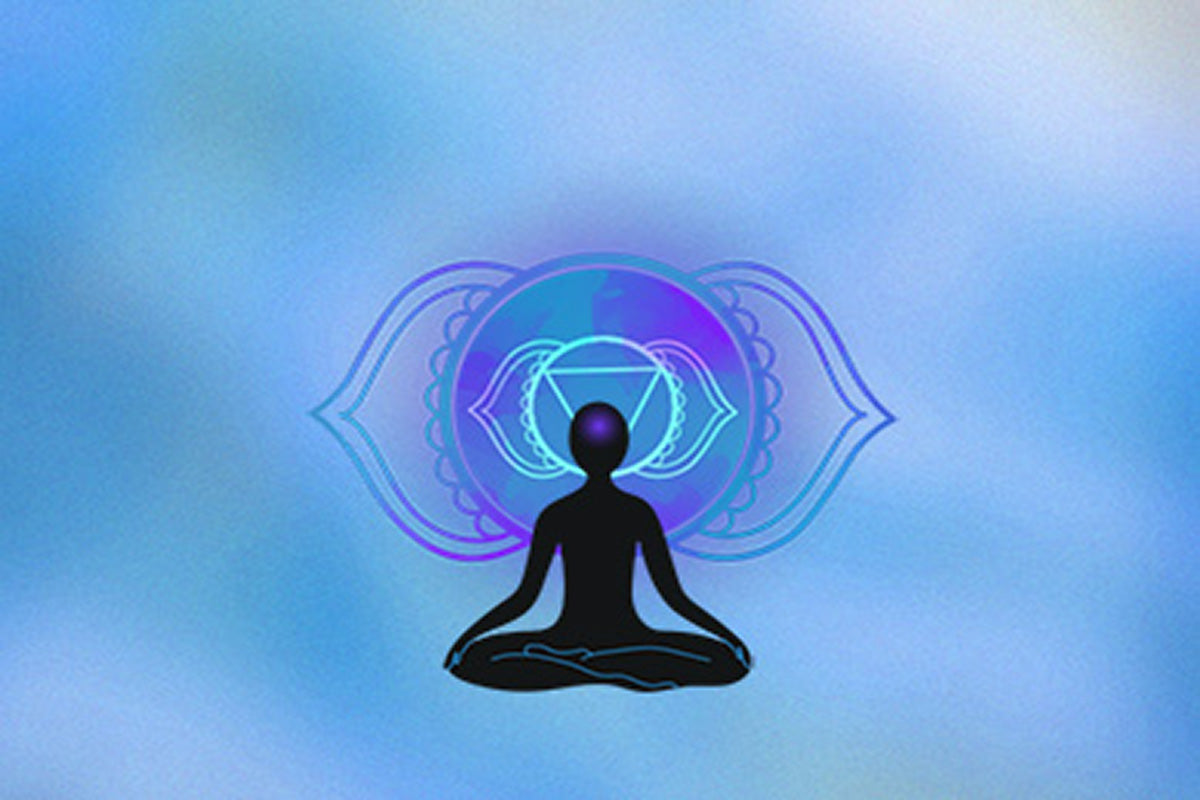 Silhouette of a meditating figure against a soft blue background, adorned with a mystical chakra symbol in pastel hues.