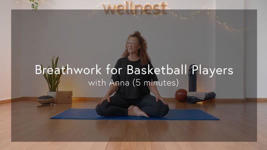 A person sits cross-legged on a yoga mat in a serene room, surrounded by plants and fitness equipment, promoting wellness and tranquility.