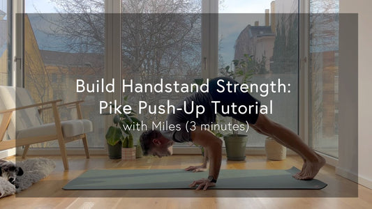 A person performing a yoga pose on a mat in a sunlit room filled with indoor plants, with a view of trees outside.