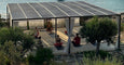 A serene outdoor yoga session under a solar-paneled roof, with participants practicing mindfulness by the water's edge.