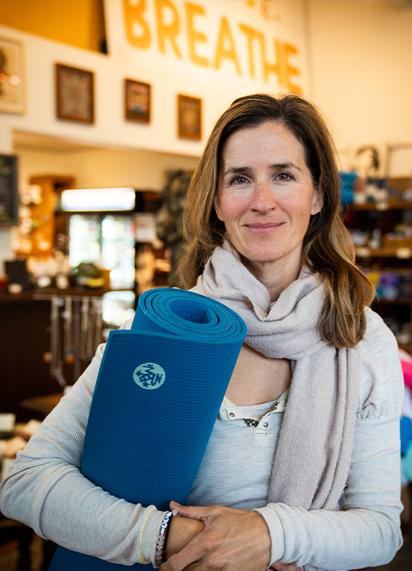 Linda Baffa holding a Manduka Yoga Mat